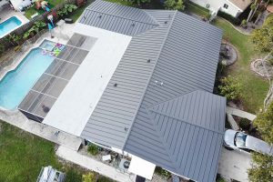 A sky shot of large newly built luxury home with metal roof