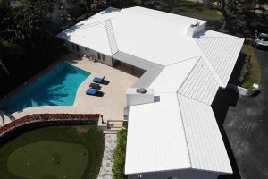 White metal roof installed on a big house with pool in residential area of florida 