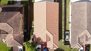 Aerial shot of 3 Florida houses with beautiful roofs side by side